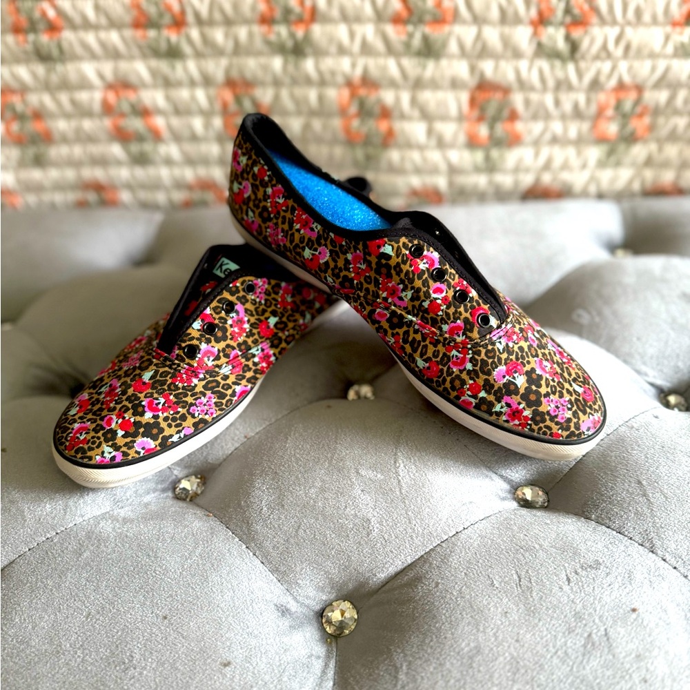 Black women’s flowered keds. Easy slip ons and no shoe strings required.